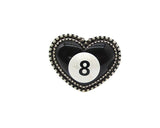 Heart-shaped object with an 8-ball design on a white background